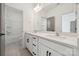 Bright bathroom with double sink vanity, white cabinets, and tiled shower at 15238 Ravenall Dr, Huntersville, NC 28078