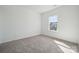An airy bedroom with soft neutral carpeting, large windows and plenty of natural light at 15238 Ravenall Dr, Huntersville, NC 28078