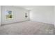 Large bedroom featuring two windows letting in plenty of natural light and soft, neutral carpeting at 15238 Ravenall Dr, Huntersville, NC 28078