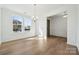 Bright dining room with hardwood floors, large windows, and stylish lighting fixture at 15238 Ravenall Dr, Huntersville, NC 28078