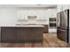 Modern kitchen with stainless steel appliances, white cabinets, and a large island at 15238 Ravenall Dr, Huntersville, NC 28078