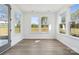 Bright sunroom with large windows offering scenic outdoor views, plus neutral flooring at 15238 Ravenall Dr, Huntersville, NC 28078