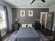 Serene bedroom featuring a stylish accent wall, cozy bedding, and contemporary decor at 1934 Hollybrook Ln, Lancaster, SC 29720