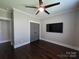 Bedroom features hardwood floors, dark wood closet doors, and a ceiling fan at 1934 Hollybrook Ln, Lancaster, SC 29720