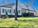 Charming exterior with landscaped lawn, manicured bushes, and a three car garage at 1934 Hollybrook Ln, Lancaster, SC 29720