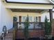Close-up of the home's entrance featuring a cozy porch swing, decorative door, and tidy landscaping at 1934 Hollybrook Ln, Lancaster, SC 29720