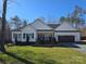 Charming single-story home with a well-manicured front lawn, attached garage, and inviting curb appeal at 1934 Hollybrook Ln, Lancaster, SC 29720