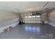 Spacious two-car garage with ample lighting, epoxy flooring, and overhead storage at 1934 Hollybrook Ln, Lancaster, SC 29720
