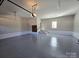 Spacious garage with neutral walls, gray flooring, and easy access to stairs at 1934 Hollybrook Ln, Lancaster, SC 29720