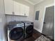 Convenient laundry room features modern Samsung washer and dryer and overhead cabinets at 1934 Hollybrook Ln, Lancaster, SC 29720