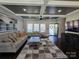 Bright and inviting living room featuring a coffered ceiling, large windows, and stylish furnishings at 1934 Hollybrook Ln, Lancaster, SC 29720