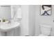 Stylish half-bathroom with modern fixtures, pedestal sink, and sleek toilet design at 208 Parker Claire Ln, Kings Mountain, NC 28086