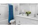 Bright bathroom featuring a double vanity, framed mirrors, and a shower with blue curtain at 208 Parker Claire Ln, Kings Mountain, NC 28086