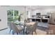 Dining room area with modern table, chairs, and open view of the kitchen with barstool seating at 208 Parker Claire Ln, Kings Mountain, NC 28086