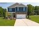 Charming two-story home with stone accents, a two-car garage, and a well-manicured lawn at 208 Parker Claire Ln, Kings Mountain, NC 28086