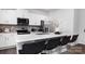 Modern kitchen features stainless steel appliances, a breakfast bar, and white cabinets at 208 Parker Claire Ln, Kings Mountain, NC 28086