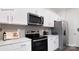 Modern kitchen features stainless steel appliances, white cabinets, and ample counter space at 208 Parker Claire Ln, Kings Mountain, NC 28086