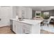 Kitchen boasts an island with seating, stainless steel appliances, and white cabinets at 208 Parker Claire Ln, Kings Mountain, NC 28086