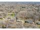 An aerial view of a wooded neighborhood showcasing the surrounding landscape and home exteriors at 211 Kingsway Cir, Charlotte, NC 28214