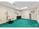 Finished basement featuring a rocking chair and accent lighting at 211 Kingsway Cir, Charlotte, NC 28214