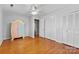 Spacious bedroom featuring hardwood floors, neutral walls, and good closet space at 211 Kingsway Cir, Charlotte, NC 28214