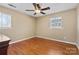 This bedroom features hardwood floors, a ceiling fan, and natural light from two windows at 211 Kingsway Cir, Charlotte, NC 28214