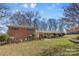 Lovely brick home with manicured shrubs and a charming, covered entrance at 211 Kingsway Cir, Charlotte, NC 28214
