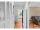 Inviting hallway with hardwood floors, view to the kitchen, and access to other living spaces at 211 Kingsway Cir, Charlotte, NC 28214