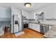 Modern kitchen with stainless steel appliances, granite countertops, and hardwood floors at 211 Kingsway Cir, Charlotte, NC 28214