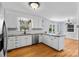 Well-lit kitchen with white cabinetry, stainless steel appliances, and a view of the backyard at 211 Kingsway Cir, Charlotte, NC 28214