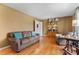 Cozy living room featuring hardwood floors, comfortable seating, and a classic bookshelf at 211 Kingsway Cir, Charlotte, NC 28214