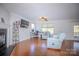 Bright living room featuring hardwood floors, a fireplace, and comfortable seating at 2111 Bennett Woods Ct, Charlotte, NC 28216