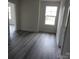 Bright bedroom featuring luxury vinyl plank flooring and a window at 212 Sugar Hill Rd, Troutman, NC 28166