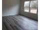 Bedroom with two large windows for plenty of natural light, and wood look vinyl flooring at 212 Sugar Hill Rd, Troutman, NC 28166