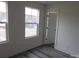 Two windows provide natural light in this bedroom with plank floors and fresh paint at 212 Sugar Hill Rd, Troutman, NC 28166