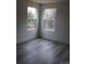 Bedroom with two large windows and wood look vinyl flooring at 212 Sugar Hill Rd, Troutman, NC 28166