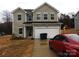 Two-story home featuring a two car garage and a cozy front yard at 212 Sugar Hill Rd, Troutman, NC 28166