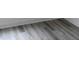 Grey wood look vinyl flooring with white baseboards at 212 Sugar Hill Rd, Troutman, NC 28166