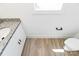 Bright bathroom featuring wood grain floors, a white cabinet and a granite countertop at 230 Georgia Sw St, Concord, NC 28025