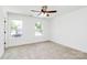 Bedroom with neutral carpet, white walls, white trim, and two windows overlooking the street at 230 Georgia Sw St, Concord, NC 28025