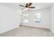 Bright bedroom featuring neutral carpet, white walls, two windows, and modern ceiling fan at 230 Georgia Sw St, Concord, NC 28025