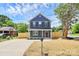 Charming two-story home with blue siding, a well-manicured lawn, and a wood fence at 230 Georgia Sw St, Concord, NC 28025