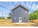 New two-story home with blue siding, a fenced yard, and a concrete patio at 230 Georgia Sw St, Concord, NC 28025