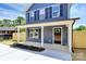 Inviting blue two-story home with a covered front porch, newly planted landscaping, and a freshly sealed front door at 230 Georgia Sw St, Concord, NC 28025
