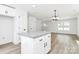 Kitchen island featuring stone countertops, modern hardware, and an open layout at 230 Georgia Sw St, Concord, NC 28025
