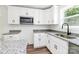 Modern kitchen design featuring stylish granite counters and modern hardware at 230 Georgia Sw St, Concord, NC 28025
