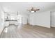 Open floor plan with kitchen island, modern lighting and neutral paint at 230 Georgia Sw St, Concord, NC 28025