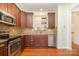 Kitchen featuring stainless steel appliances, granite countertops, tile backsplash and wood cabinets at 243 Lincoln St, Charlotte, NC 28203