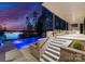 Backyard pool at twilight, with steps leading to the house and picturesque lake view at 2536 Brawley School Rd, Mooresville, NC 28117