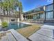 A modern backyard with a pool, mature trees, and ample space, ideal for outdoor entertaining and relaxation at 2536 Brawley School Rd, Mooresville, NC 28117